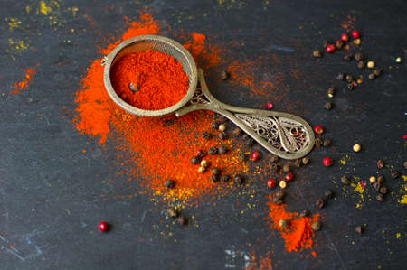 Paprika pepper spices and wintage silverware on rustic backgroundの写真素材