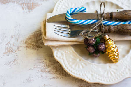 Christmas table setiing with vintage silverware and christmas decoration on rustic wooden table