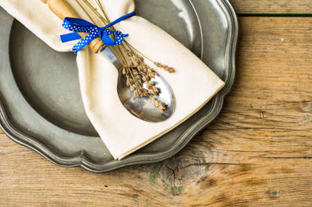 Rustic table setting with vintage plate and silverware with lavender