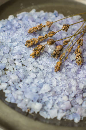 Flowers of dried lavender flowers and sea salt on vintage plateの写真素材
