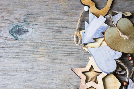 Wooden old-styled decorations for Christmas holidays on rustic backgroundの写真素材