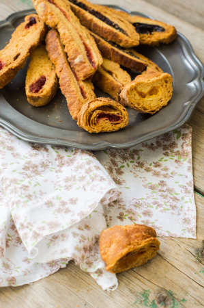 Biscotti on vintage plate on old wooden rustic table