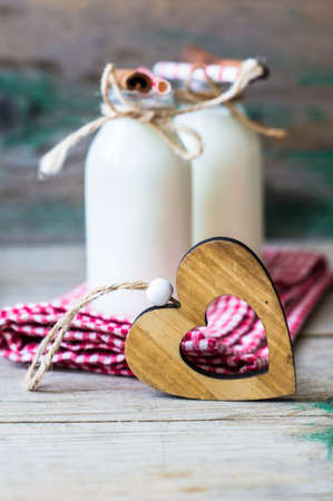 Vintage style bottles with milk and spices on rustic backgroundの写真素材