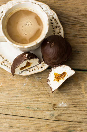 chocolate covered marshmallows or german schokokuss with cup of coffee with milk