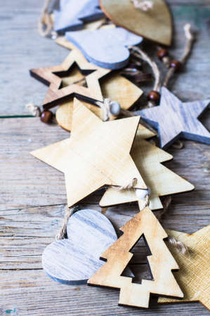 Wooden old-styled decorations for Christmas holidays on rustic backgroundの写真素材