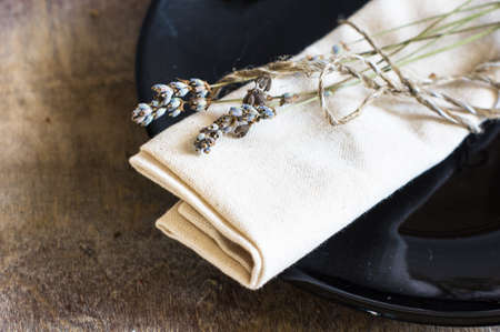 Rustic table setting with vintage silverware and plate with dried lavender flowersの写真素材