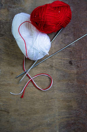 Vintage Knitting needles and yarn on wooden rustic table