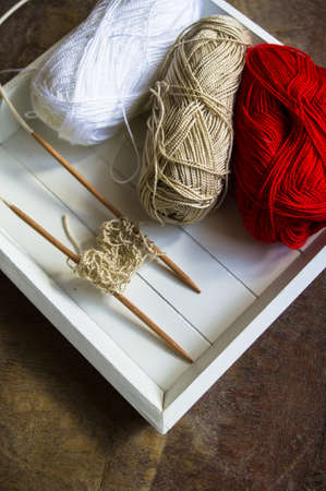 Vintage Knitting needles and yarn on wooden rustic table
