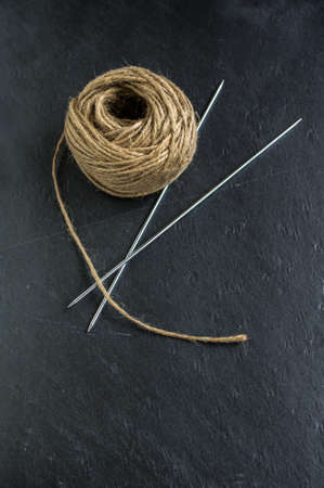 Vintage Knitting needles and yarn on wooden rustic table