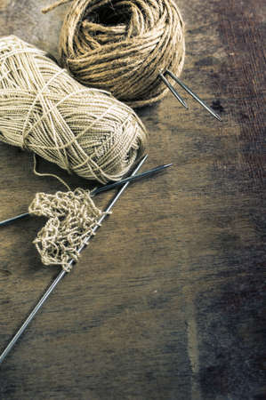 Vintage Knitting needles and yarn on wooden rustic table. Toned image