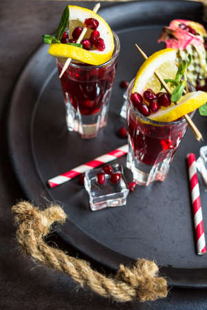 Healthy food,  fresh pomegranate cocktail with lemon on rustic background. Selective focus