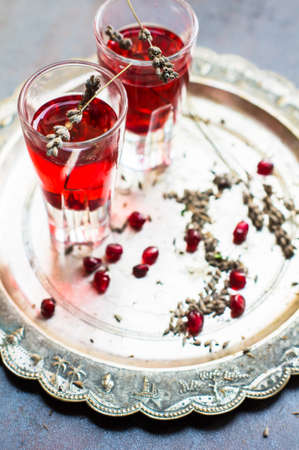 Healthy food,  fresh pomegranate cocktail with lavender flowers on vintage background. Selective focusの写真素材