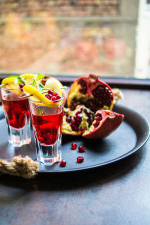 Healthy food,  fresh pomegranate cocktail with lemon on rustic background. Selective focusの写真素材
