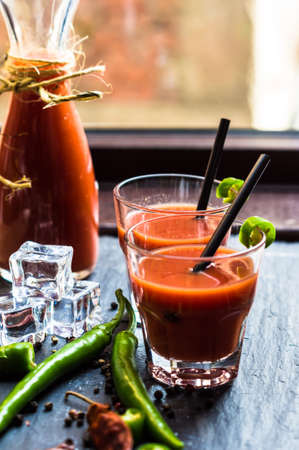 Fresh tomato juice with cherry tomatoes and chili pepper on rustic backgroundの写真素材