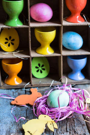 Easter eggs in a vintage box on rustic background