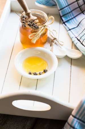 Honey and lavender flowers on old rustic background