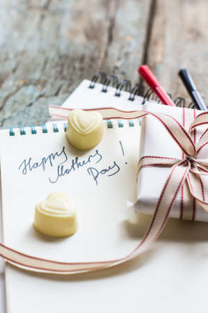 Present box and spring snowball flowers for Mothers Day on rustic backgroundの写真素材