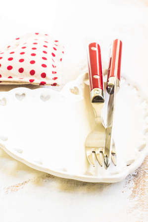 Vintage table set with hearts and silverware on rustic backgroundの写真素材