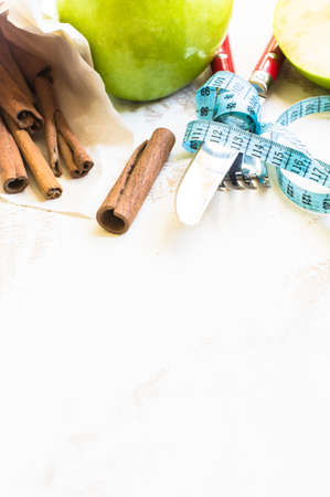 Weight loss concept with  green apple and measure tape on rustic wooden backgrounfの写真素材