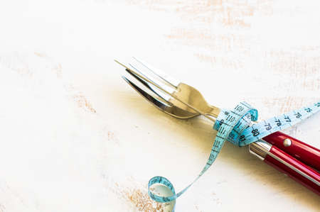 Table setting with measuring tape and vintage silverwareの写真素材