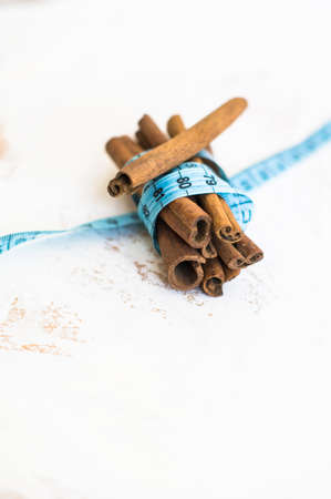 Cinnamon sticks and measure tapeの写真素材