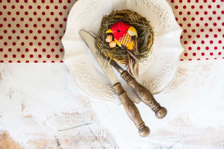 Table setting for Easter celebration with colorul easter eggs in vintage styleの写真素材