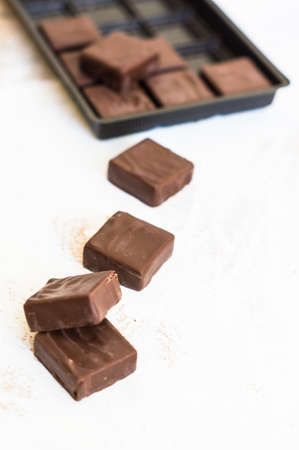 Chocolate candies on the wooden white backgroundの写真素材