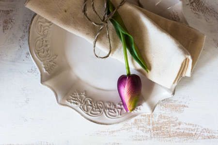 Spring time table setting with tulip flowers and vintage style silverware and tablewareの写真素材