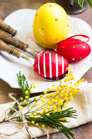 Table setting for Easter festive dinner with mimosa flowers