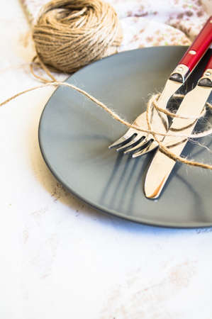 Rustic table setting with vintage silverware and bright color napkinの写真素材