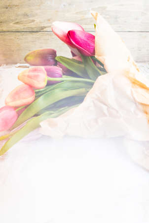 bouquet of colorful tulips on rustic wooden board, easter decorationの写真素材
