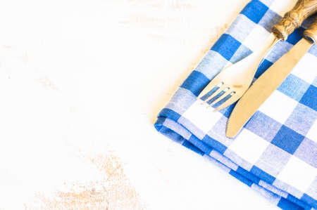 Rustic table setting with vintage silverware and bright color napkinの写真素材