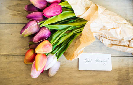 bouquet of colorful tulips on rustic wooden board, easter decorationの写真素材