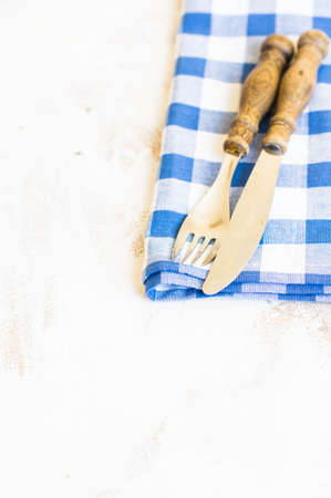 Rustic table setting with vintage silverware and bright color napkinの写真素材