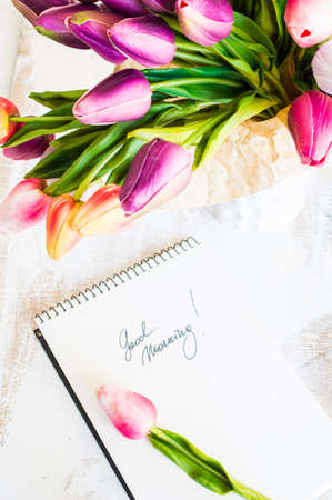 bouquet of colorful tulips on rustic wooden board, easter decorationの写真素材