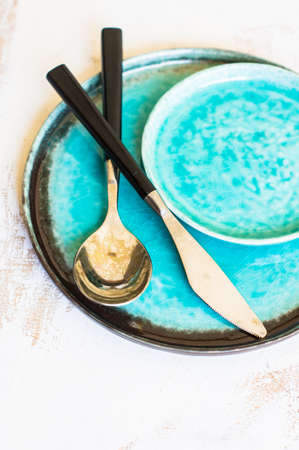 Rustic table setting with vintage silverware and bright color napkinの写真素材