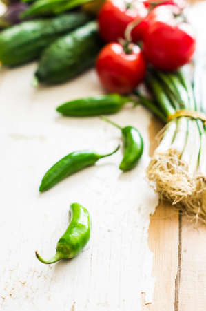 Fresh organic vegetables like a tomatoes, cucumer, green peper,  spinach and parsley on rustic wooden backgroundの写真素材