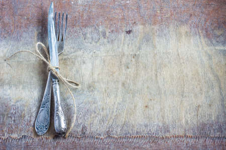 Rustic table setting with vintage silverware  on old wooden table. View from above with copy spaceの写真素材