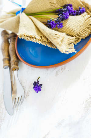 Elegant spring table setting with delicate  muscari flowers. Selective focus