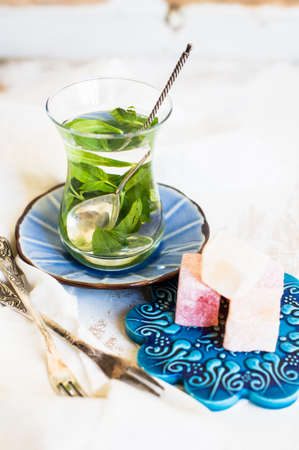 Traditional turkish dessert - mint tea and bakhlava on rustic background