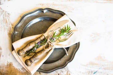 Summer time table setting with fresh rosemary spice on rustic backgroundの写真素材