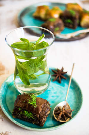 Traditional turkish dessert - mint tea and bakhlava on rustic backgroundの写真素材