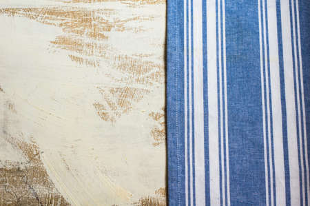 Kitchen towel or napkin  over the rustic wooden table. View from above with copy space