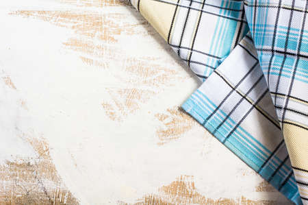 Kitchen towel or napkin  over the rustic wooden table. View from above with copy space