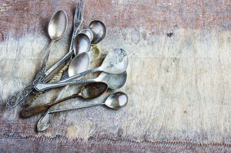 Rustic table setting with vintage silverware  on old wooden table. View from above with copy space