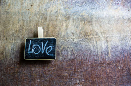 Word Love on small chalkboard on rustic wooden backgroundの写真素材