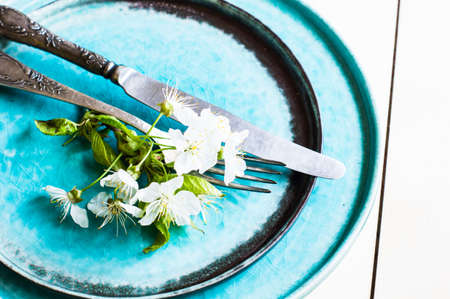 Spring time table setting with rustic plates and cherry blossomの写真素材