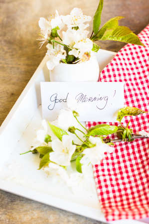 Spring time cherry blossom with good morning note on the rustic table