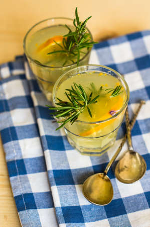 Lemon, rosemary and other and herbs detox drink on rustic backgroundの写真素材