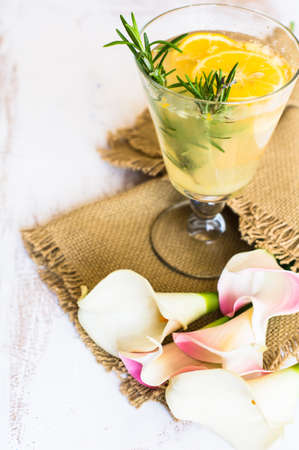 Lemon, rosemary and other and herbs detox drink on rustic backgroundの写真素材